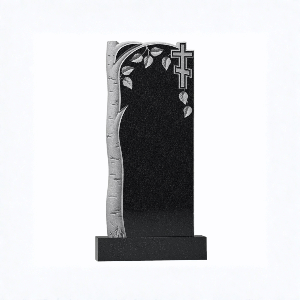 High-polished black granite upright headstone featuring a beautifully hand-carved frosted birch tree trunk, delicate leaves, and an Eastern Orthodox cross, set on a solid black base
